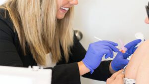Dr Hopkins gives a patient a vitamin shot in the arm
