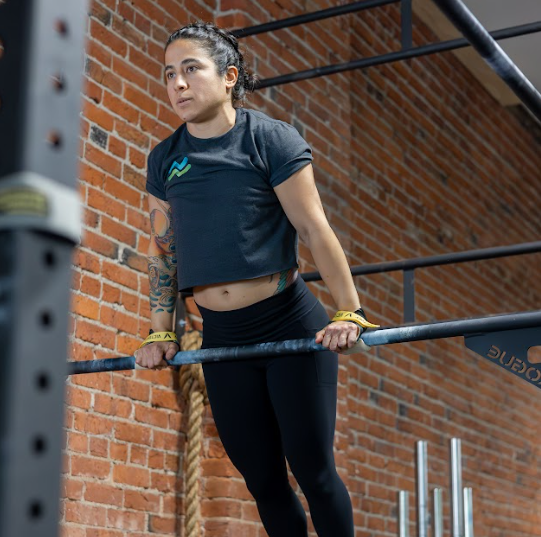 Woman exercises on parallel bar