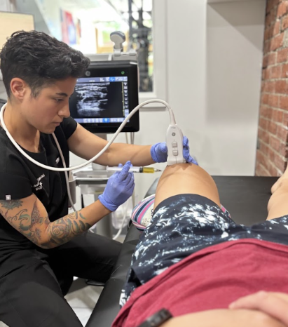 Physician performing ultrasound-guided injection for sports injury treatment in Tacoma