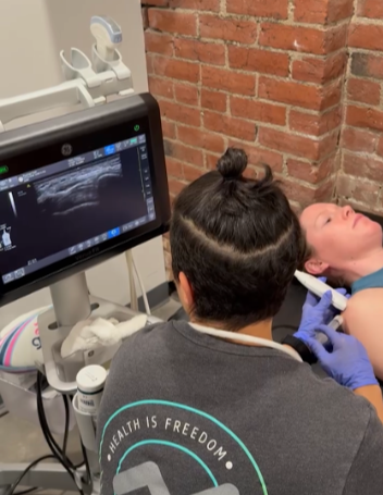 Physician performing diagnostic ultrasound for shoulder pain and rotator cuff injury assessment in Tacoma