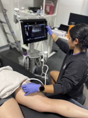Physician performing diagnostic ultrasound for hip pain evaluation in Tacoma